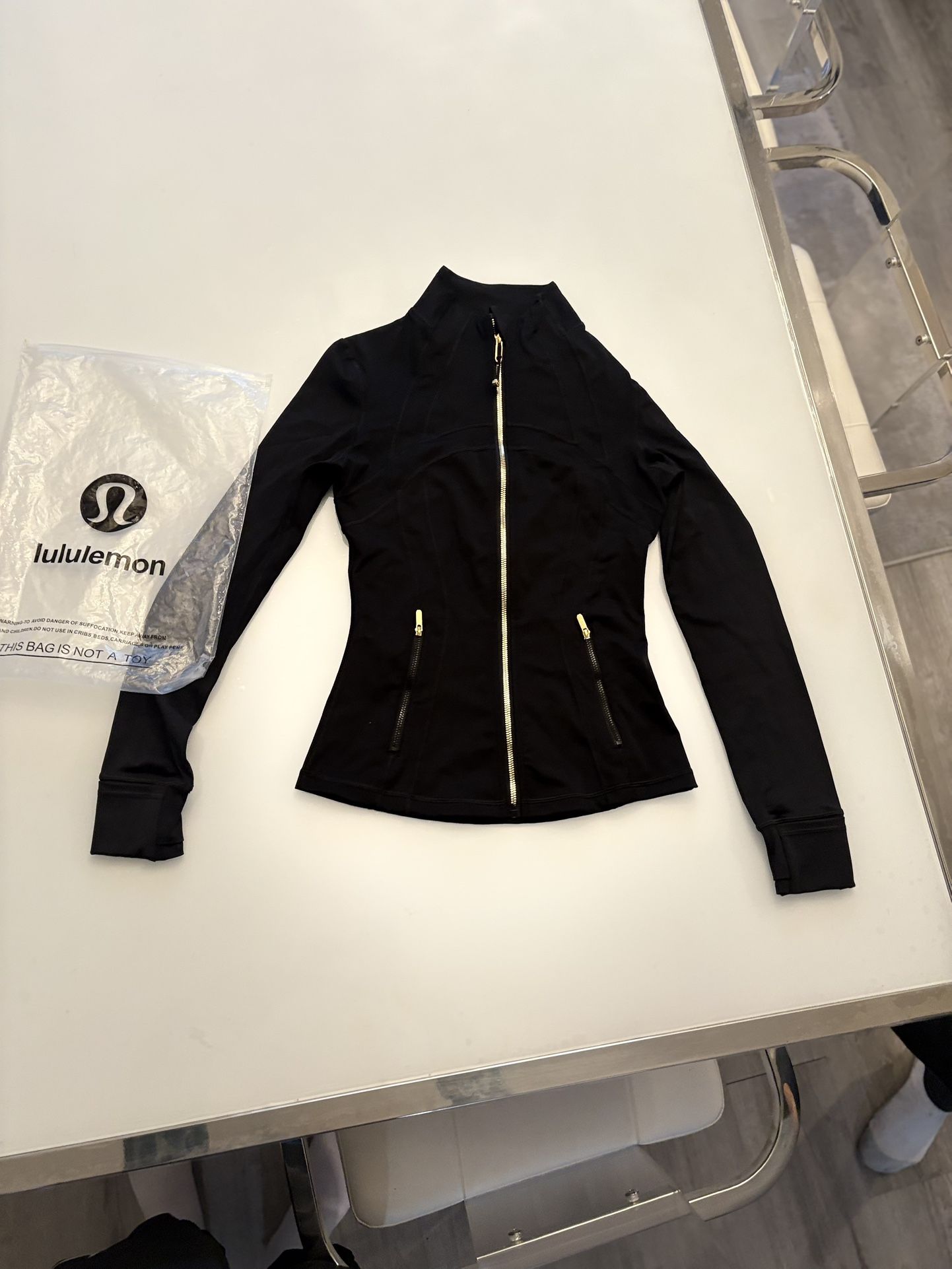 Lululemon Women's DefiJacket, Size 2 and 4, black and gold, Brand New.