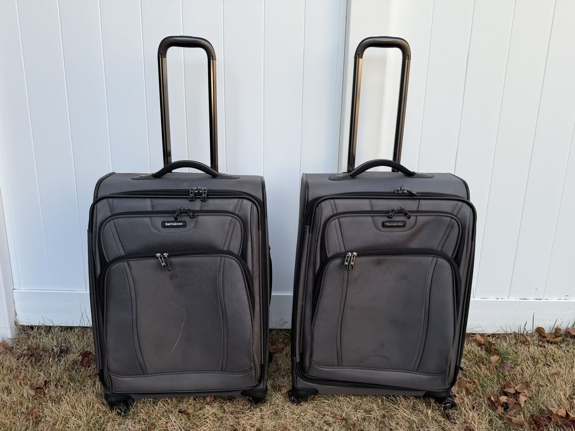 Two Samsonite grey checked rolling luggages