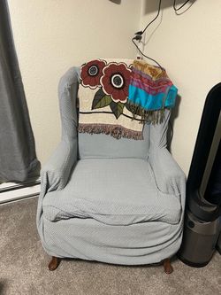 Antique wing back chair with cover