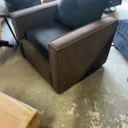 This is a brown fabric accent chair with a black seat cushion. 