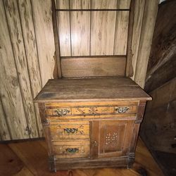 antique Eastlake Victorian oak washstand or dry sink with a towel bar, featuring ornate brass hardware and hand-carved floral accents
