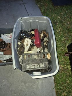 Two totes with used mower parts and more