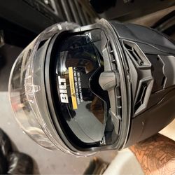 Bilt helmet with built in sunglasses. New condition