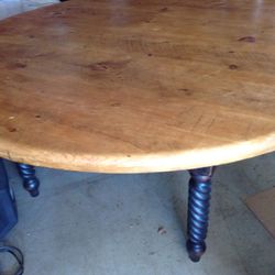 Heavy oak table with eight chairs. Also includes a large red lazy Susan for center of table measuring three feet across. Table measures Six  feet accr