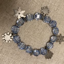 Lightweight Clear, blue faceted plastic beaded bracelet with snowflake charms.
