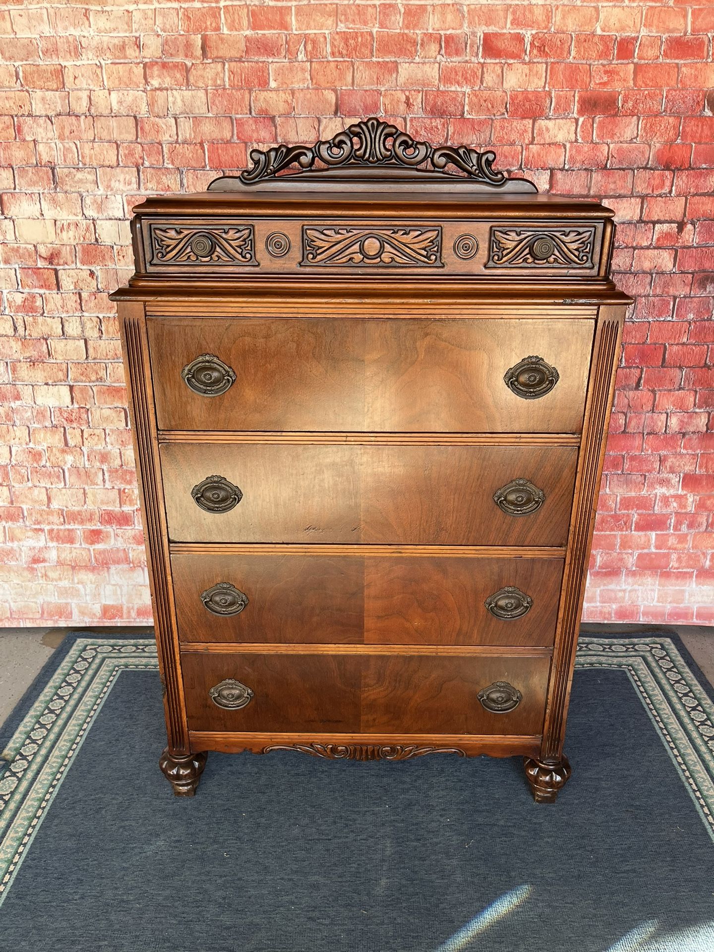 Antique highboy dresser with ornate carvings and five drawers