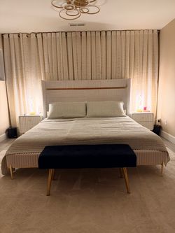 King white bed with nightstands, lamps, black bench