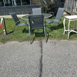 Gray  glass patio set with four chairs