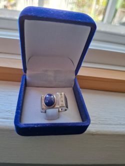 14k white gold with a Sapphire stone and Diamonds.