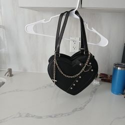 Selling a black heart purse with a ✝️ on it