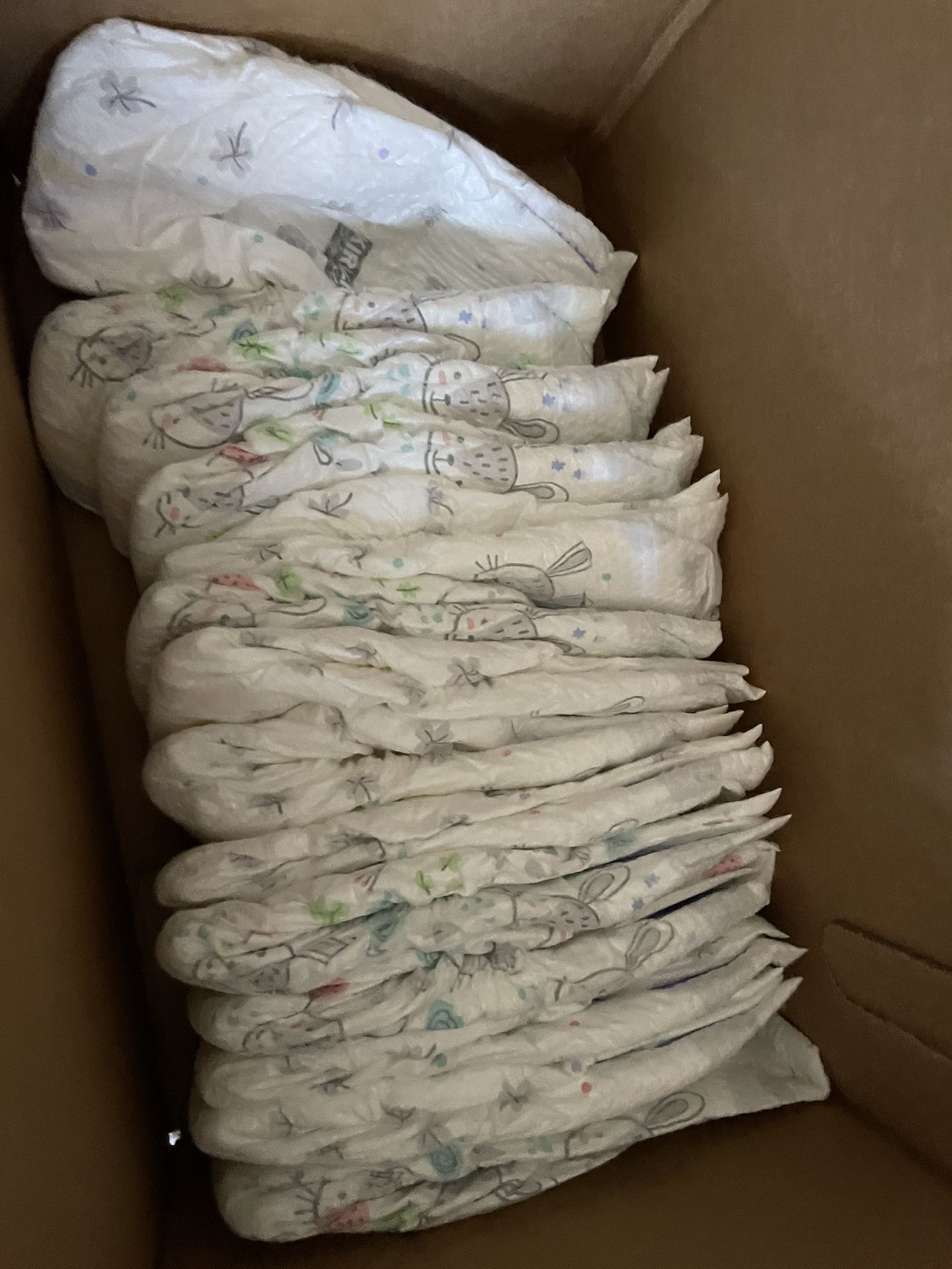 Size 3 Kirkland Diapers And New Bibs 