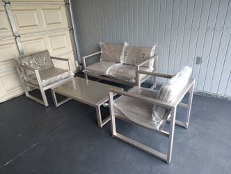 Outdoor patio couch with chairs and coffee table 