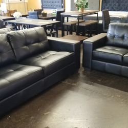 Black faux leather sofa and loveseat