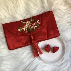 Red embroidered wallet & pair of red statement earrings