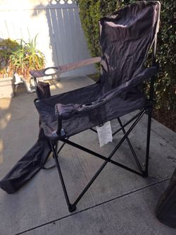 3 black beach chairs with carry bags.
