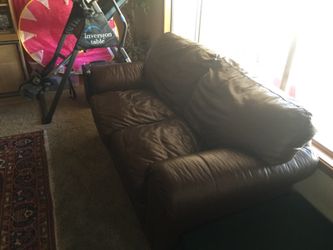 Brown leather loveseat. Mint condition and super comfortable