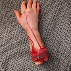 REALISTIC HALLOWEEN PROP.   13" LONG.  SOLID MATERIAL.  NEW.  PICKUP ONLY.