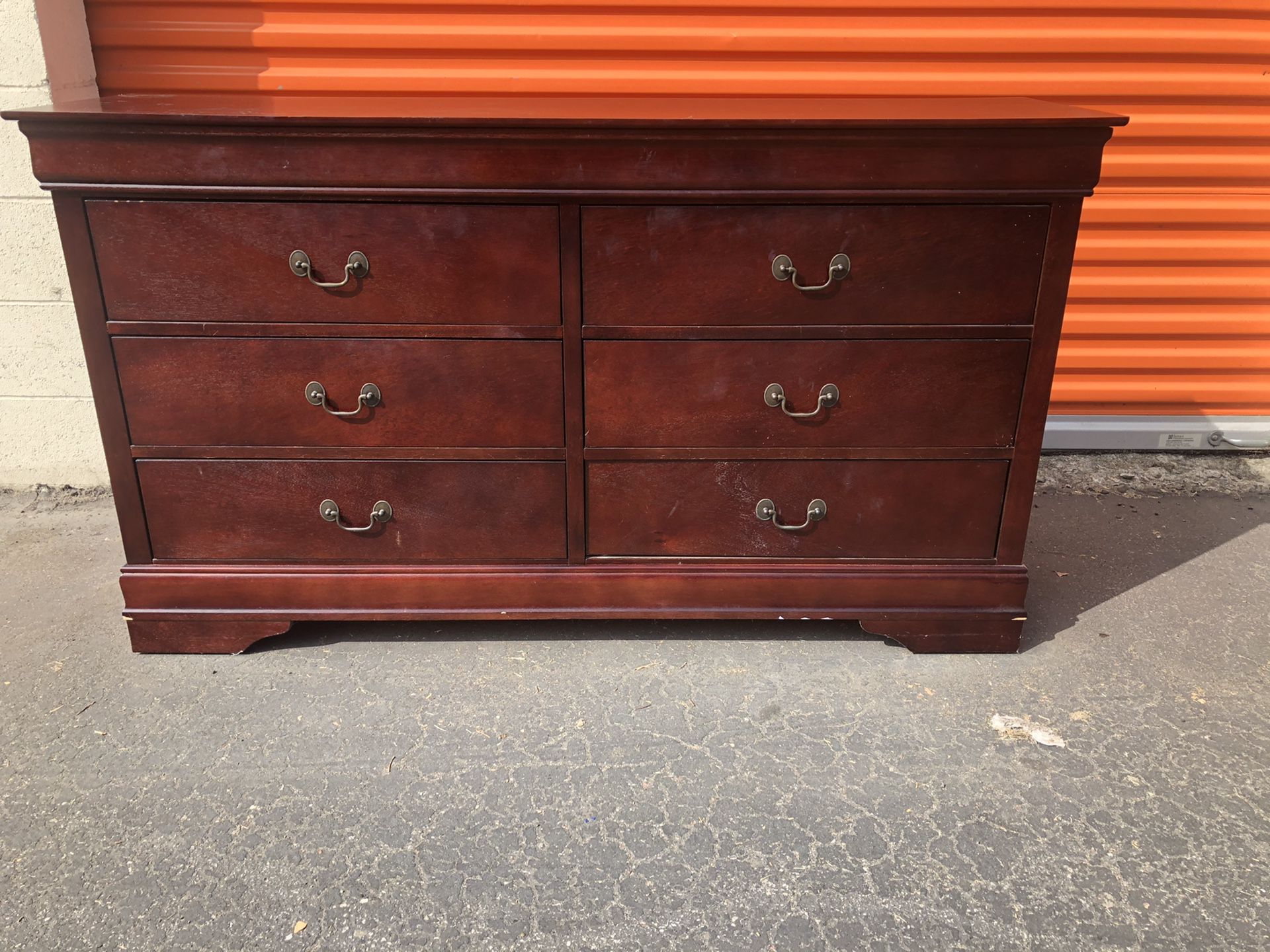 Red wooden dresser with mirror included along with matching night stand