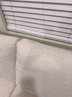 Moderately used white linen couch