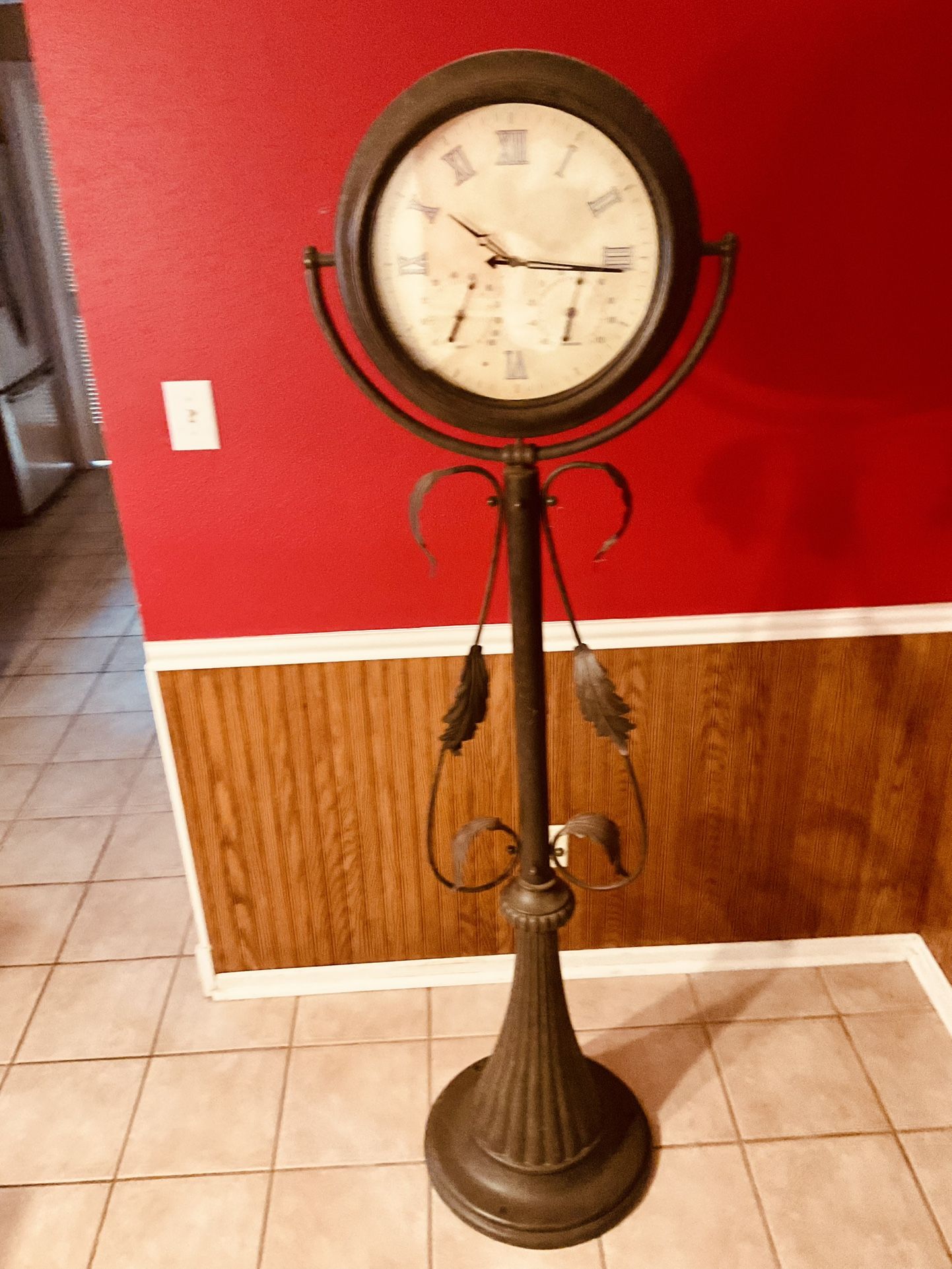 Crestview Collection 63" Metal Floor Clock with a Curled Iron Stand.