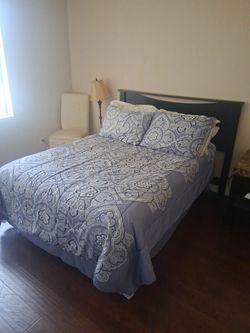 Queen bed, with chair, side table, and lamp