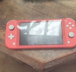 Used Nintendo Switch Lite - Coral (Pink) with Two Pokémon Games