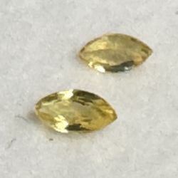These are a pair of yellow sapphire gemstones.