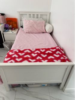 White twin bed with mattress