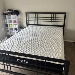 Queen-size memory foam mattress with bed frame for sale.