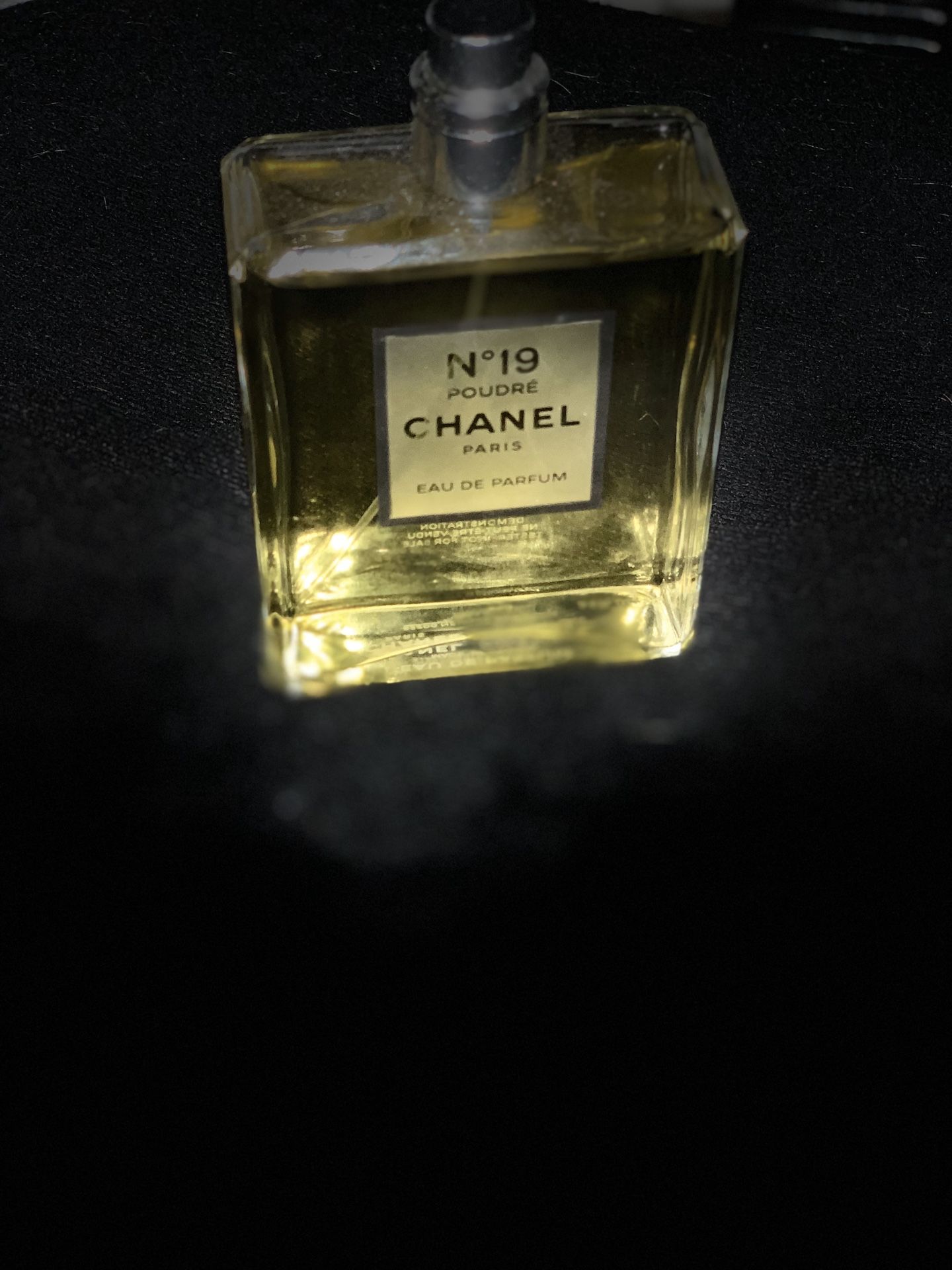 Woman's perfume Chanel No. 19 and Prada