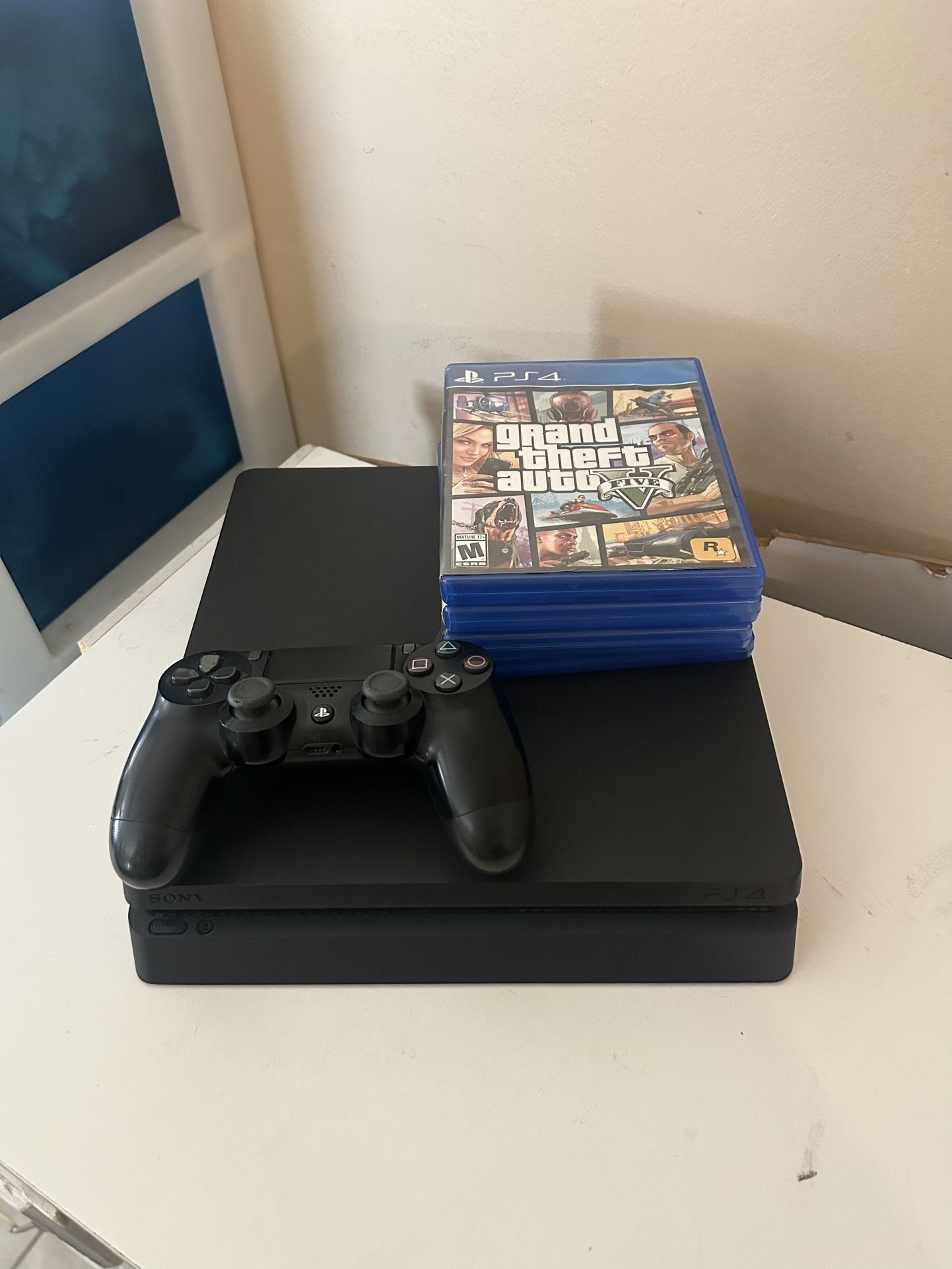 PS4 Slim + Controller & 4 Games Bundle – GTA V & NBA Series Included