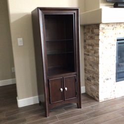 Two Tall Dark Wood Cabinets