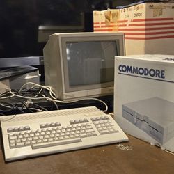 Commodore 128 Personal Computer With 1571 Disk Drive And Commodore Model 1902a.