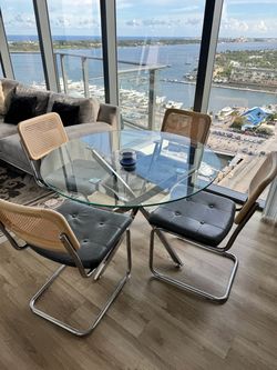 Glass Dining Table with Rattan Chairs