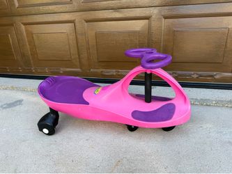 PlasmaCar Original Wiggle Car in fuchsia pink and purple, designed for indoor or outdoor use.
