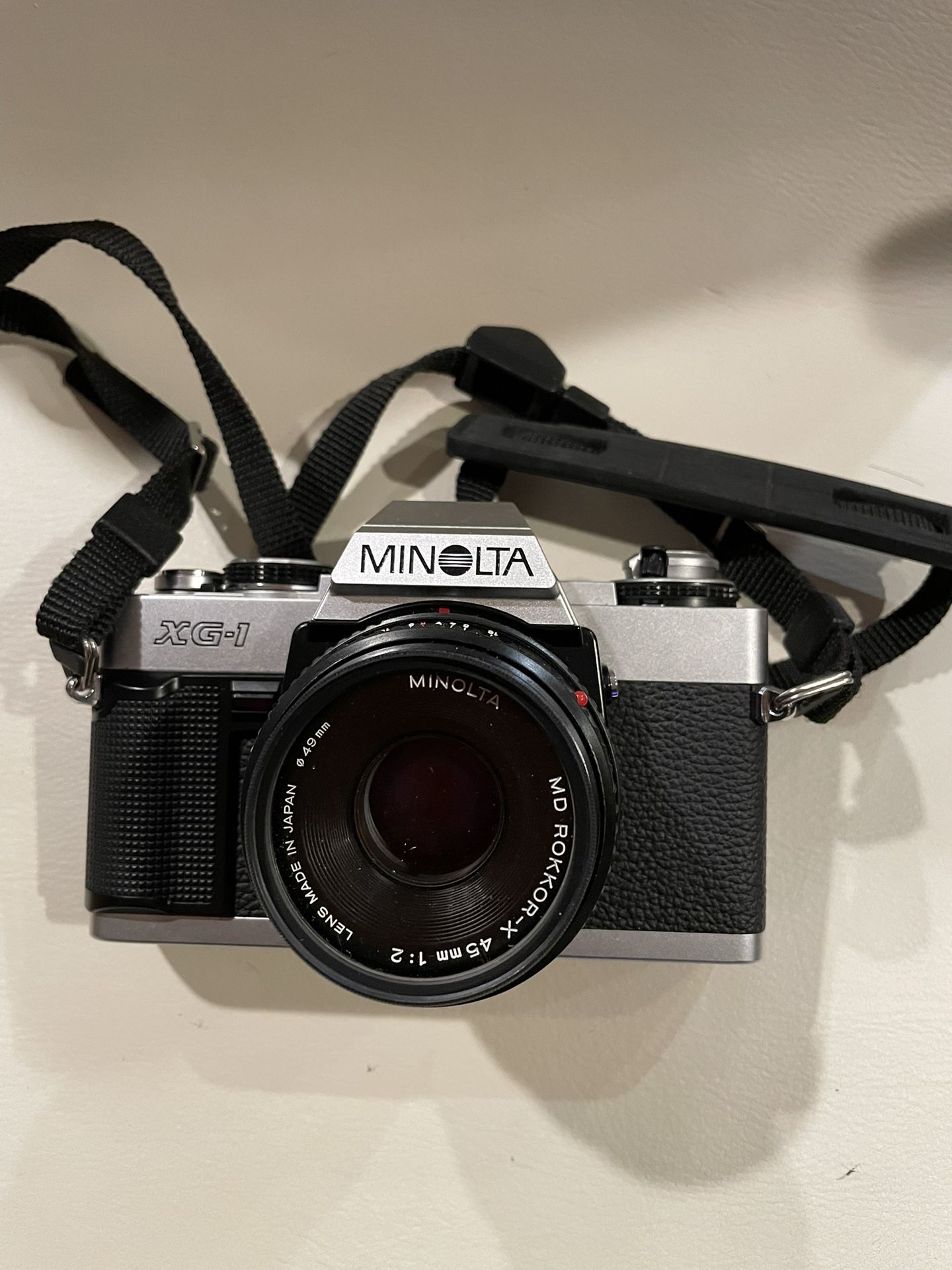 Minolta XG-1 35mm SLR film camera with a 45mm f/2 lens and UV filter.