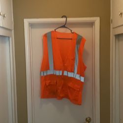 Safety vest hot orange, lime green, and another hot orange, made by iron wear. One lime, green, and two hot orange vests brown rice