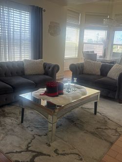 Sofas and coffee table and tv stand and tv for $1800 and free rug