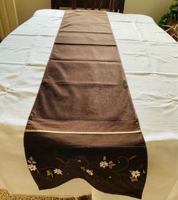 New Table Runner 72” X 14”, Brown With Embroidery And Ribbon Floral Work On Edges.
