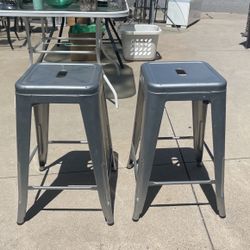 A pair of metal barstools