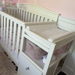 Crib with storage and attached changing table 