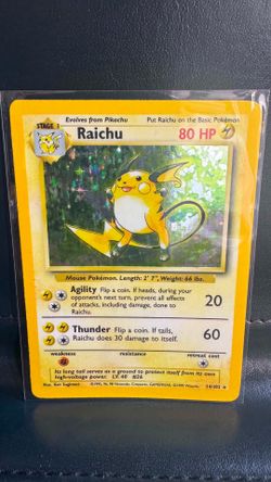 1999 Pokemon Base Set Raichu holographic card (#14/102), featuring the Stage 1 evolution character.