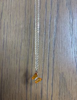 Orange butterfly pendant on gold chain with lobster claw clasp