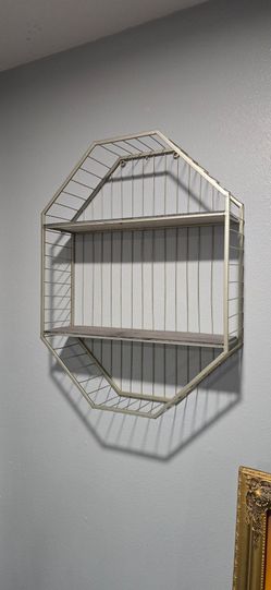 Hexagon Wall Shelf Wire 2 Shelves 27" x 20" x 6" Good Condition

Stylish wall shelf. Has a cool hexagonal shape. Gold metal wire frame with two wood s