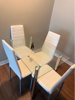 Glass table and white chairs