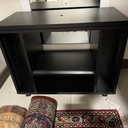 New TV console with rotating top and it has wheels in the bottom 