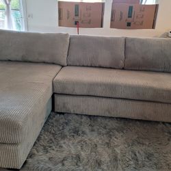 Brand New 2 PC Sectional W/pillows. Sleeps 3. Light Grey.