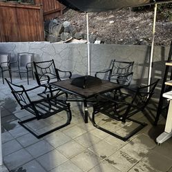 Fire Pit Table With Four Metal Chairs