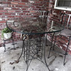 Glass table with two tall stools