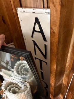 Tall vertical ANTIQUES metal black and white sign